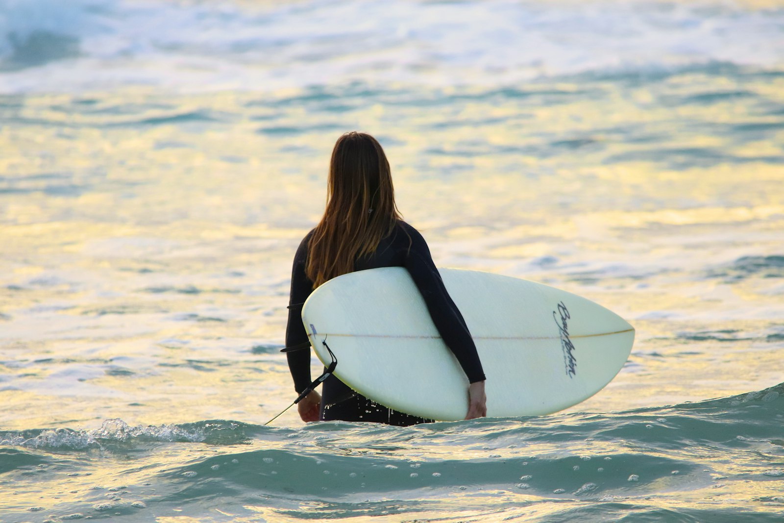 Sigma 150-500mm F5-6.3 DG OS HSM sample photo. Woman carrying surfboard photography