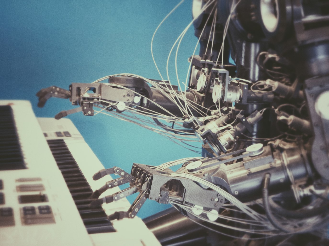 Robot playing an electronic piano.