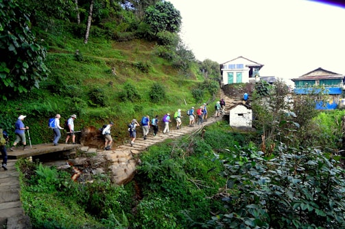 A group of friends hiking a lush trail leading to a panoramic viewpoint overlooking Búzios.