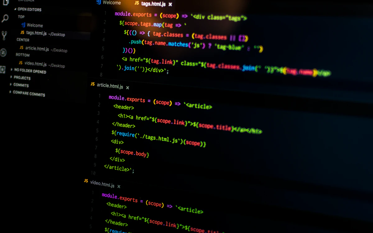 Lines of code glowing on a laptop screen in a dark workspace