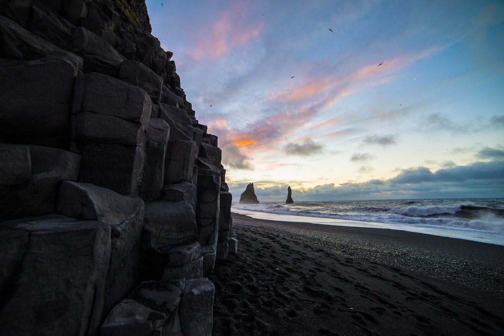 brown rock formation near sea