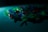 A collection of LED lights in various colors like green, blue, and orange are scattered on a surface. The scene is dimly lit, creating a soft glow and shadows, adding an atmospheric effect.