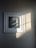 Photo of a framed artwork hanging in a cozy, sunlit room.