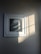 Photo of a framed artwork hanging in a cozy, sunlit room.