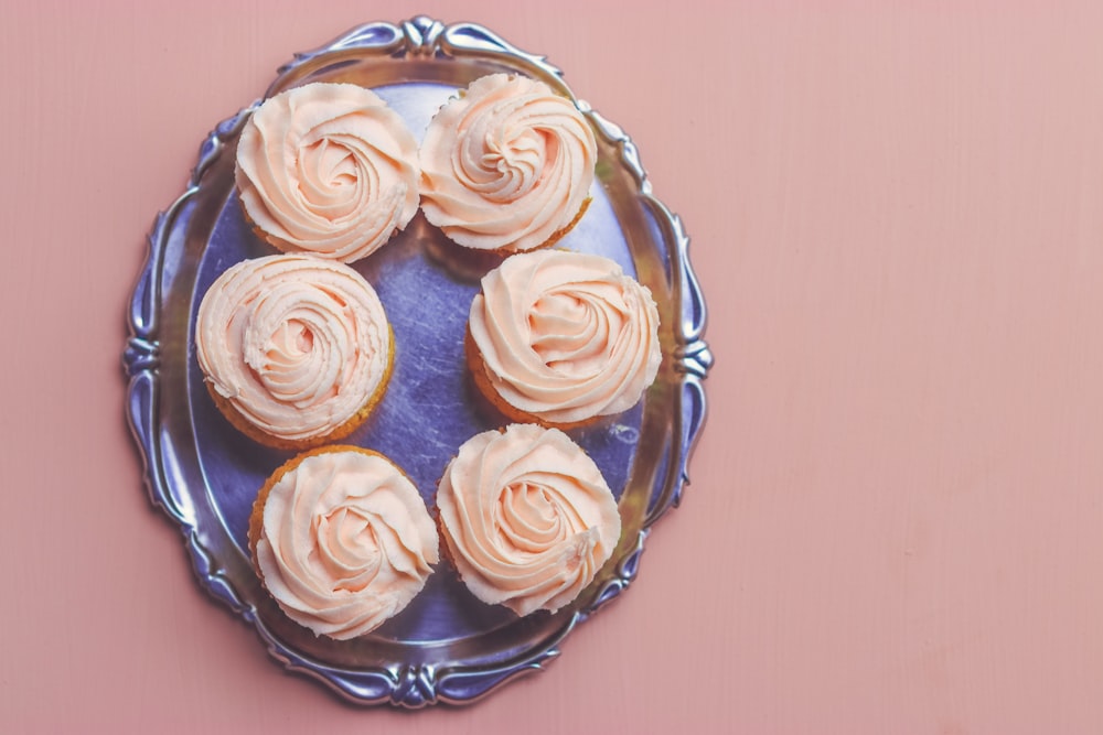 six cupcakes on stainless steel serving tray