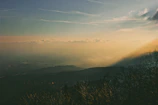 A cinematic view of the secret valley at dawn, with mist rising and dragons flying in the distance.