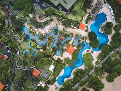 Community swimming pool surrounded by landscaped gardens.