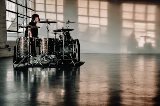 person in front of drumset