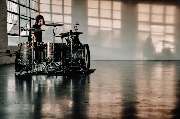 person in front of drumset