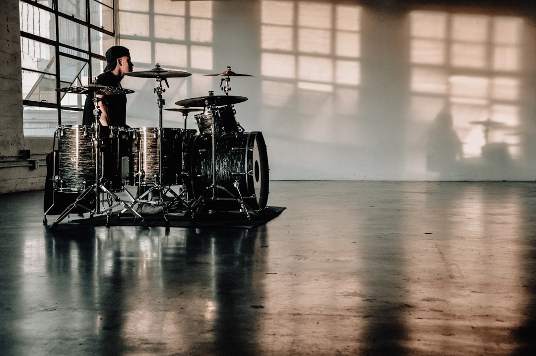 person in front of drumset,