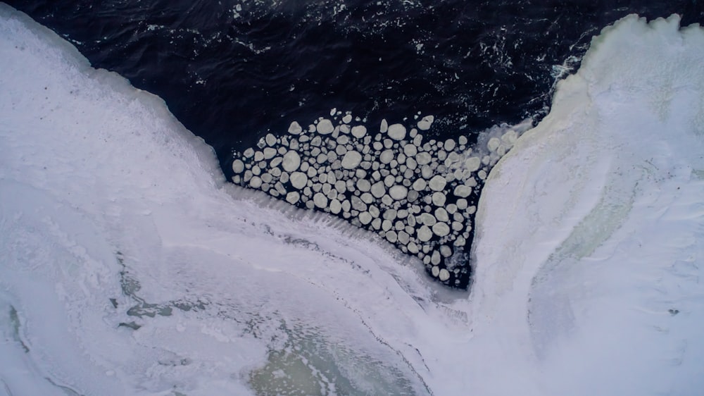 aerial photo of body of water near snow covered road