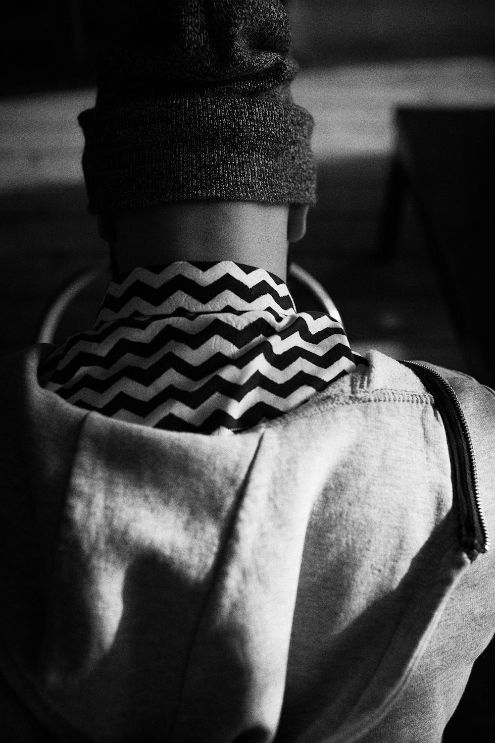 fotografia in scala di grigi di un uomo che indossa un berretto lavorato a maglia