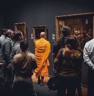 people standing in front of paintings