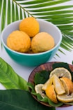 sliced lemon on teal and white ceramic bowl