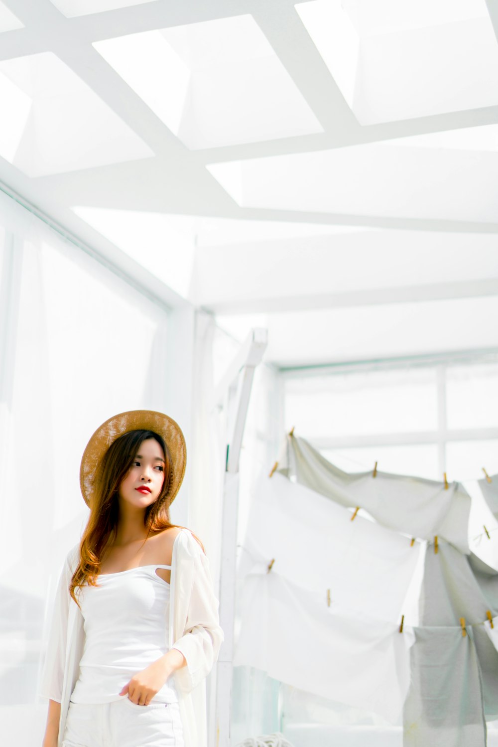 woman standing near hanging clothes