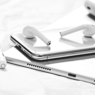 grayscale photography of iPhone X, AirPods, Apple Pencil and iPad