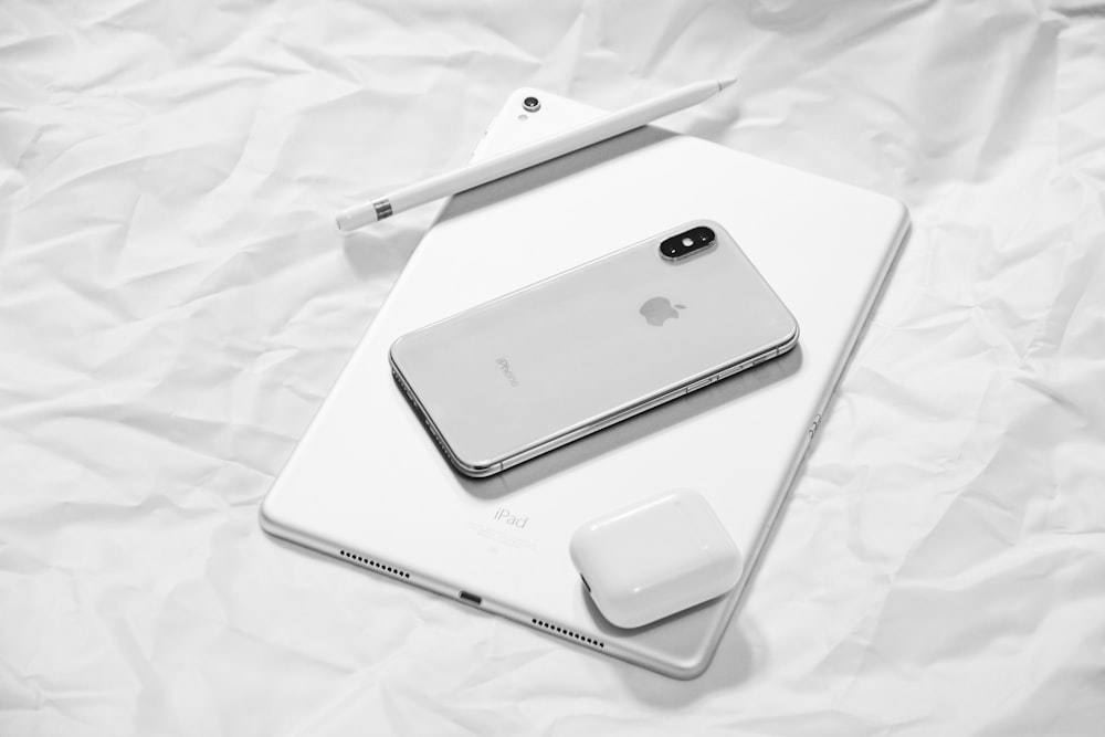 silver iPhone X with silver iPad