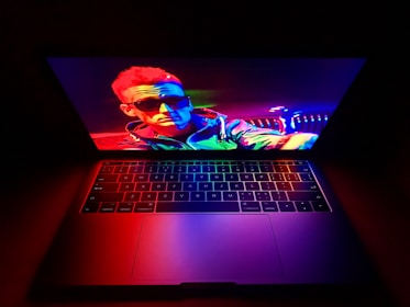 Colorful promotional campaign visuals displayed on a laptop screen.