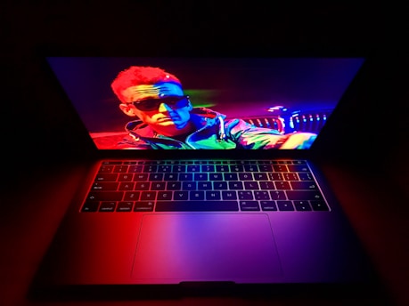 A person using a laptop with vibrant images on the screen, showcasing creativity.