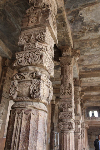 Intricate marble pillars inside a traditional Rajasthani temple, showcasing detailed artistry.