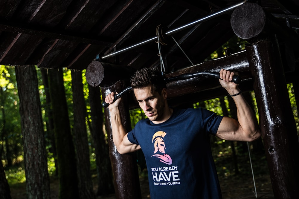 man holding latpull down machine