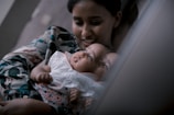 a woman holding a baby in her arms