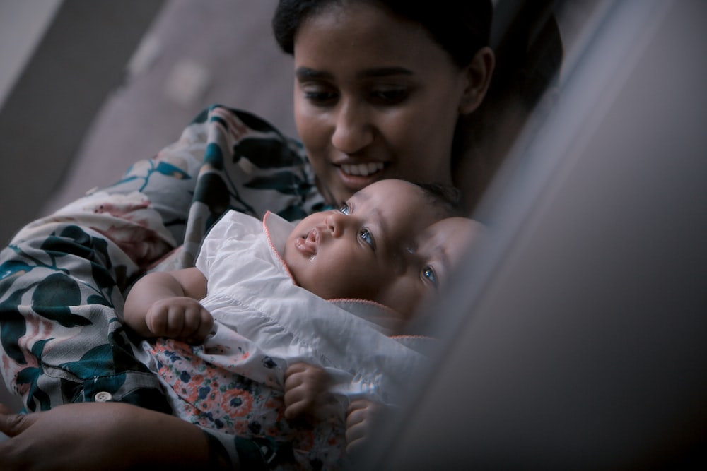 a woman holding a baby in her arms