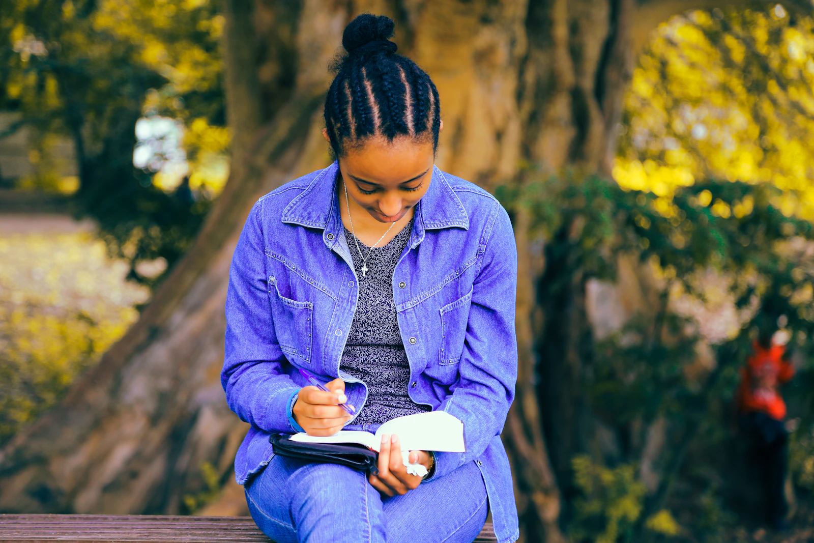 A young woman reading a book, focused on learning