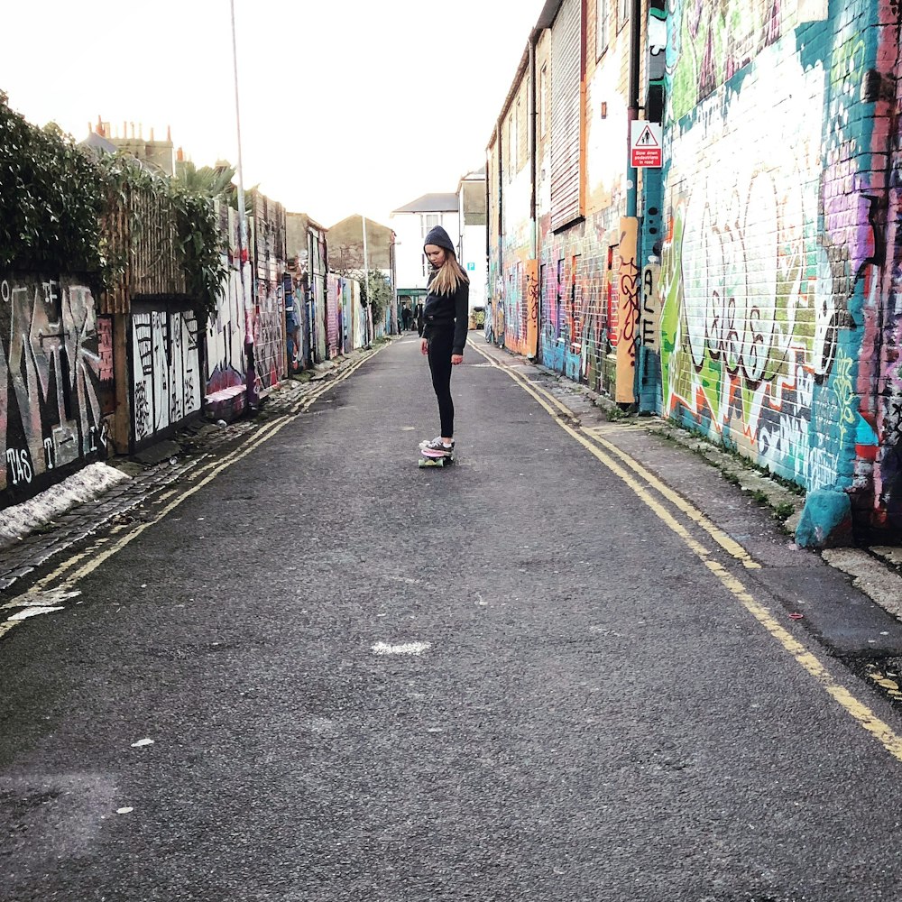 woman on skating beside building at daytime