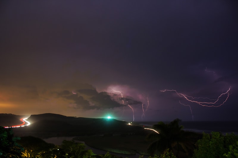 Lightning strikes over a landscape during a thunderstorm