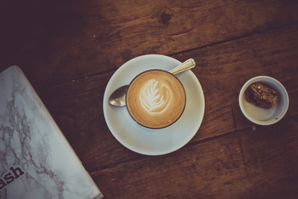 white ceramic cup on white ceramic plate