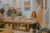 A diverse group of people reading news on various devices in a cozy setting.