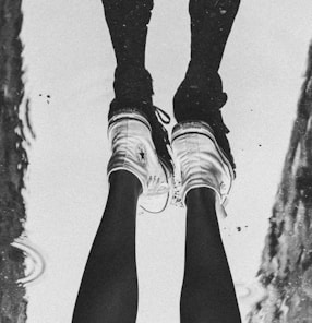 a person standing in a puddle with their feet in the water