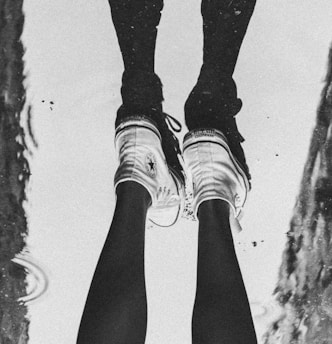 a person standing in a puddle with their feet in the water