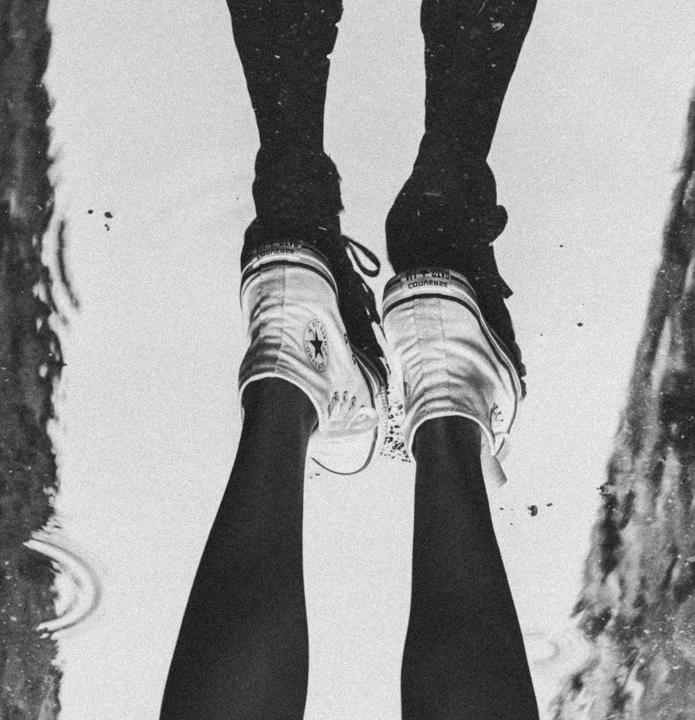 a person standing in a puddle with their feet in the water