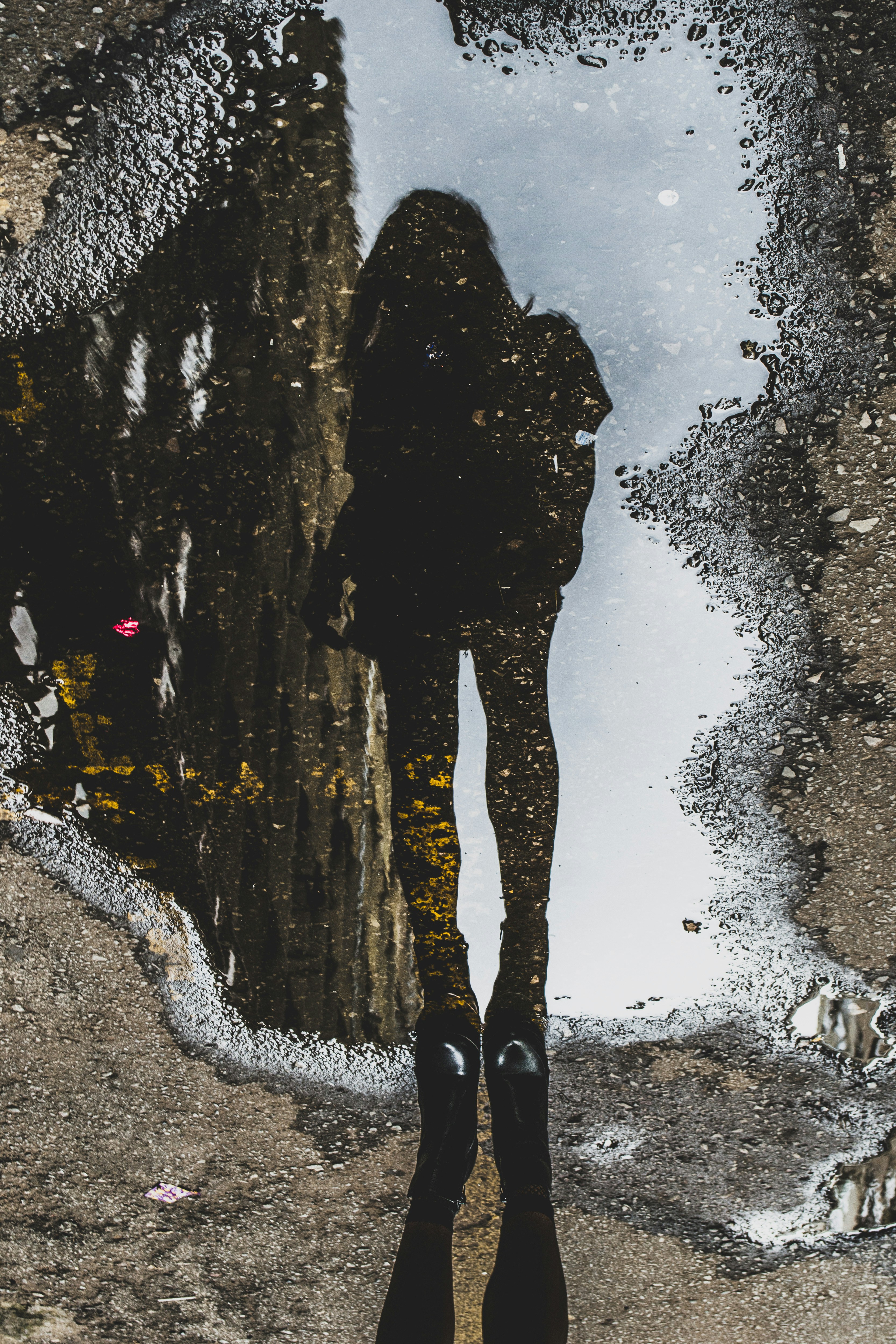 woman’s reflection in a puddle