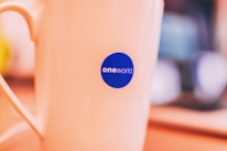 Close-up of a colorful logo printed on a white mug.