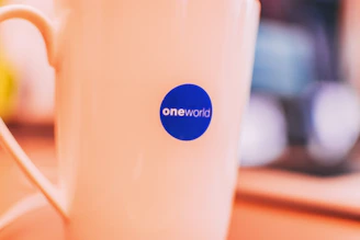 A close-up of personalized sublimation products featuring the identimark360 logo on fabric and mugs.