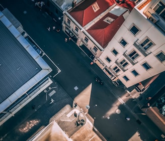 aerial photography of asphalt road between buildings