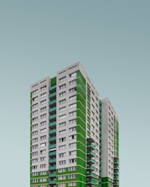 green and white concrete high-rise building at daytime