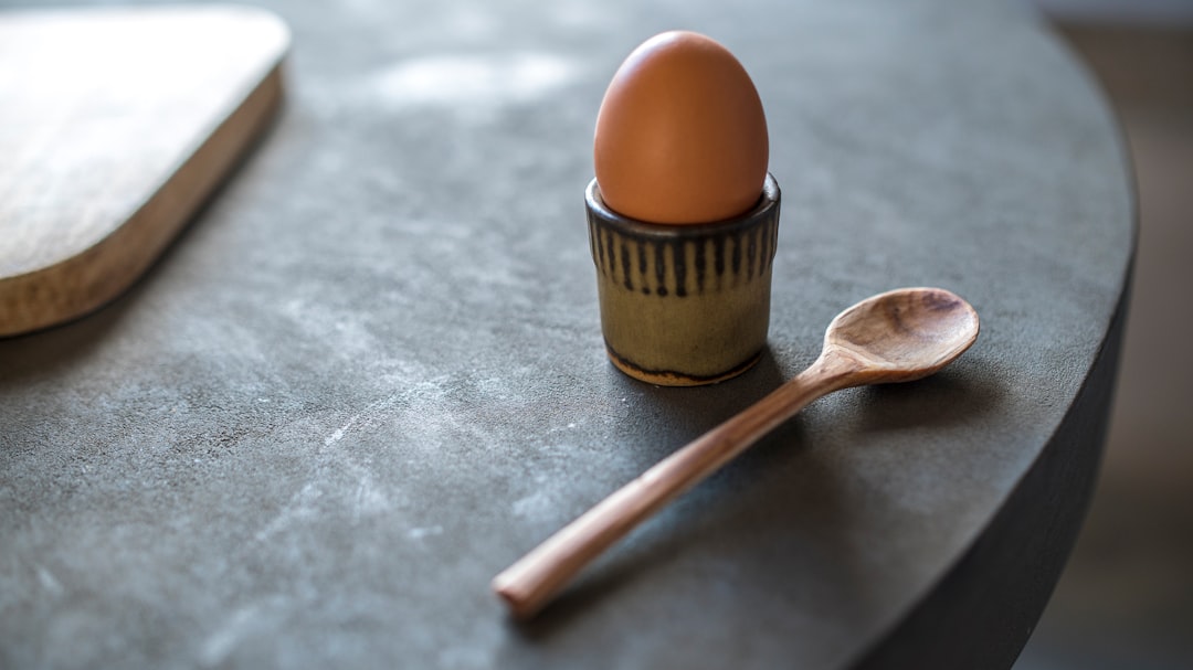 Egg and Spoon on Concrete Table