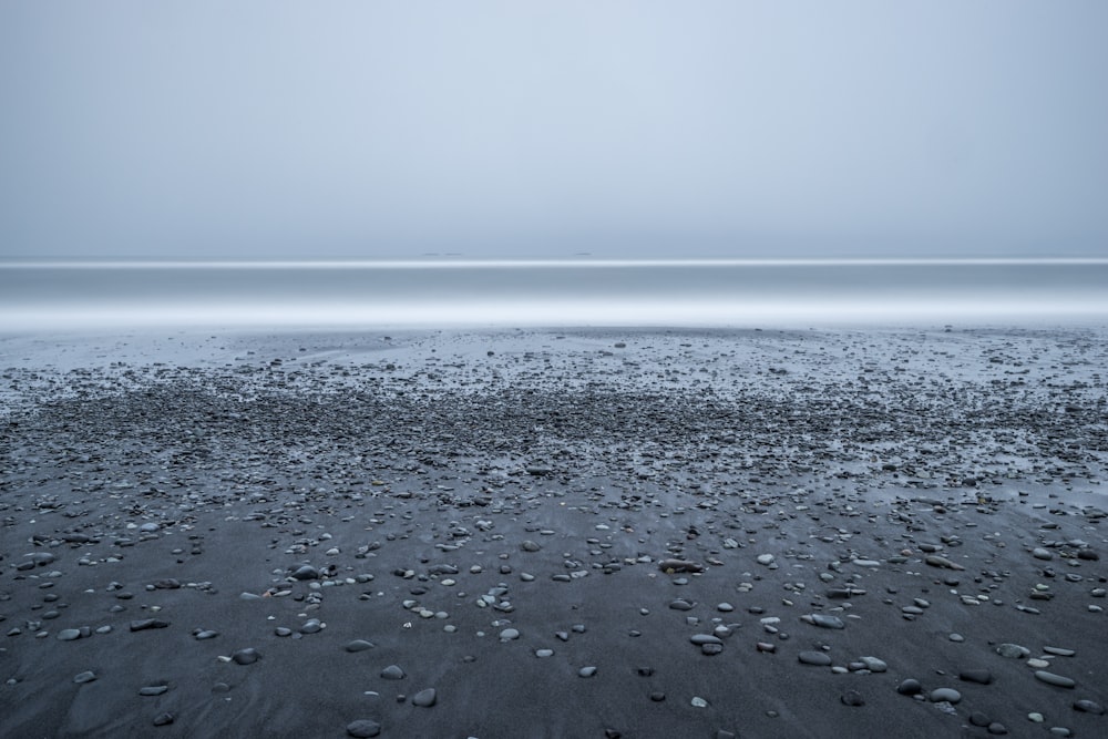 rocky beach with grey skies above sea