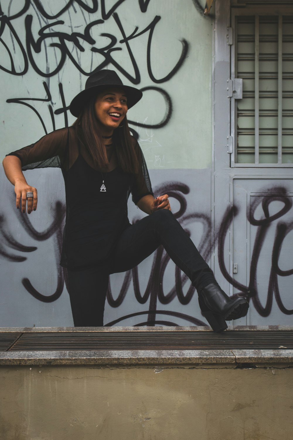 woman standing in front of wall with vandals