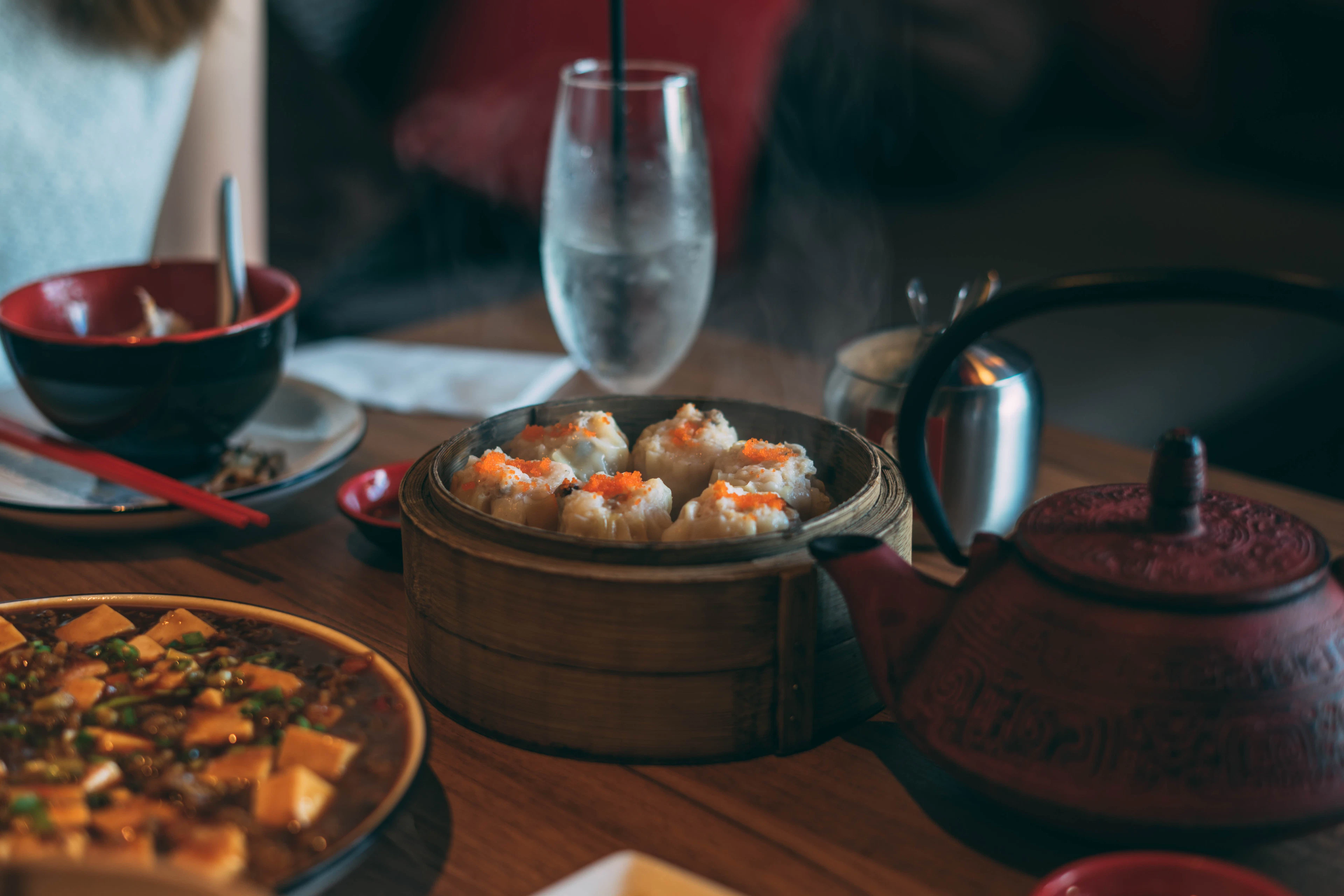 A dim-lit dish and glass on a dark counter