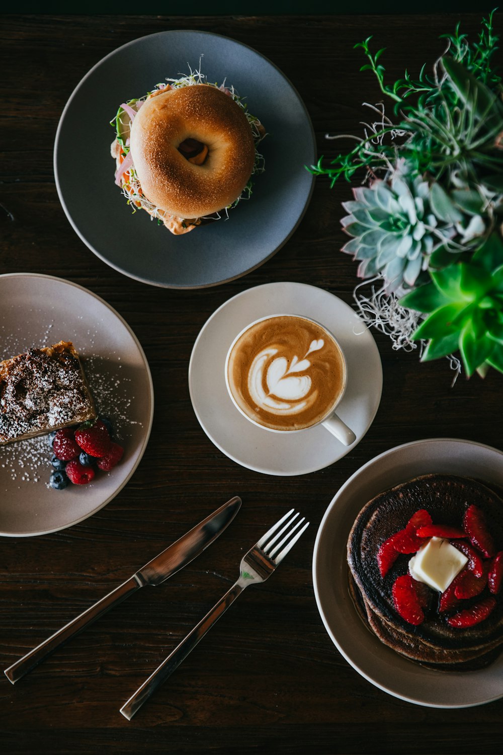 coffee with latte art surrounded with sweets