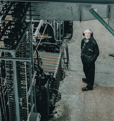 man standing on front of industrial machine
