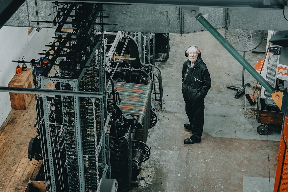 man standing on front of industrial machine