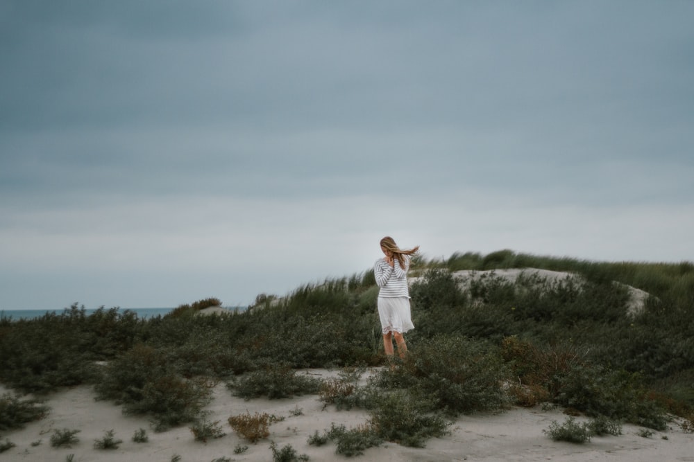 woman standing near green bush at daytime