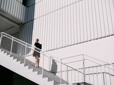 woman standing on stairway during daytime