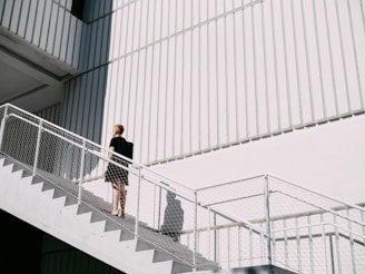 woman standing on stairway during daytime